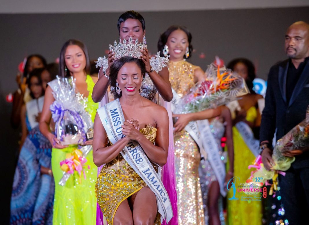 With tears of joy and hands clasped in gratitude, Dr. Gabrielle Henry bows her head as Miss Universe Jamaica 2024, Rachel Silvera, crowns her the new Miss Universe Jamaica 2025 — marking the start of an unforgettable reign. Photo by Ricardo Saint-Cyr